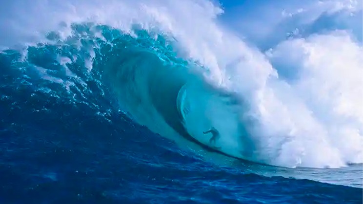 McNamara shooting the curl of Jaws, an incredibly huge and powerful wave break at Peahi Bay on the north shore of Maui, Hawaii Photograph- Ron Dahlquist_Corbis
